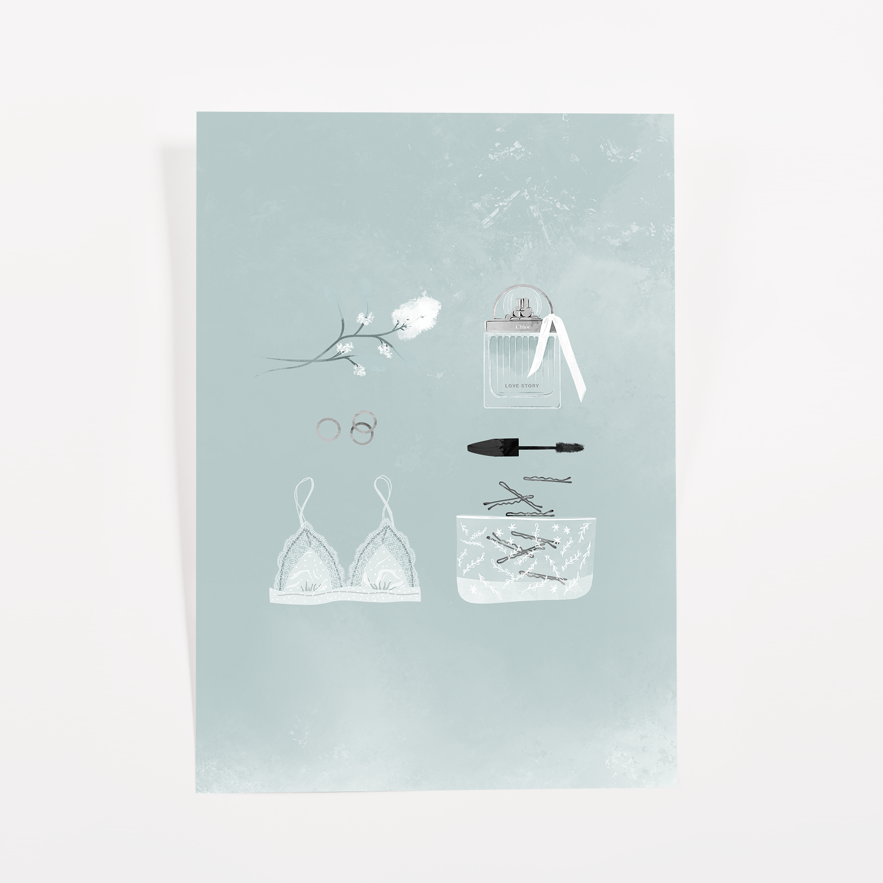 Teal journaling card with a white lace bralette, a perfume bottle with ribbon, mascara, rings, and a white blossom sprig