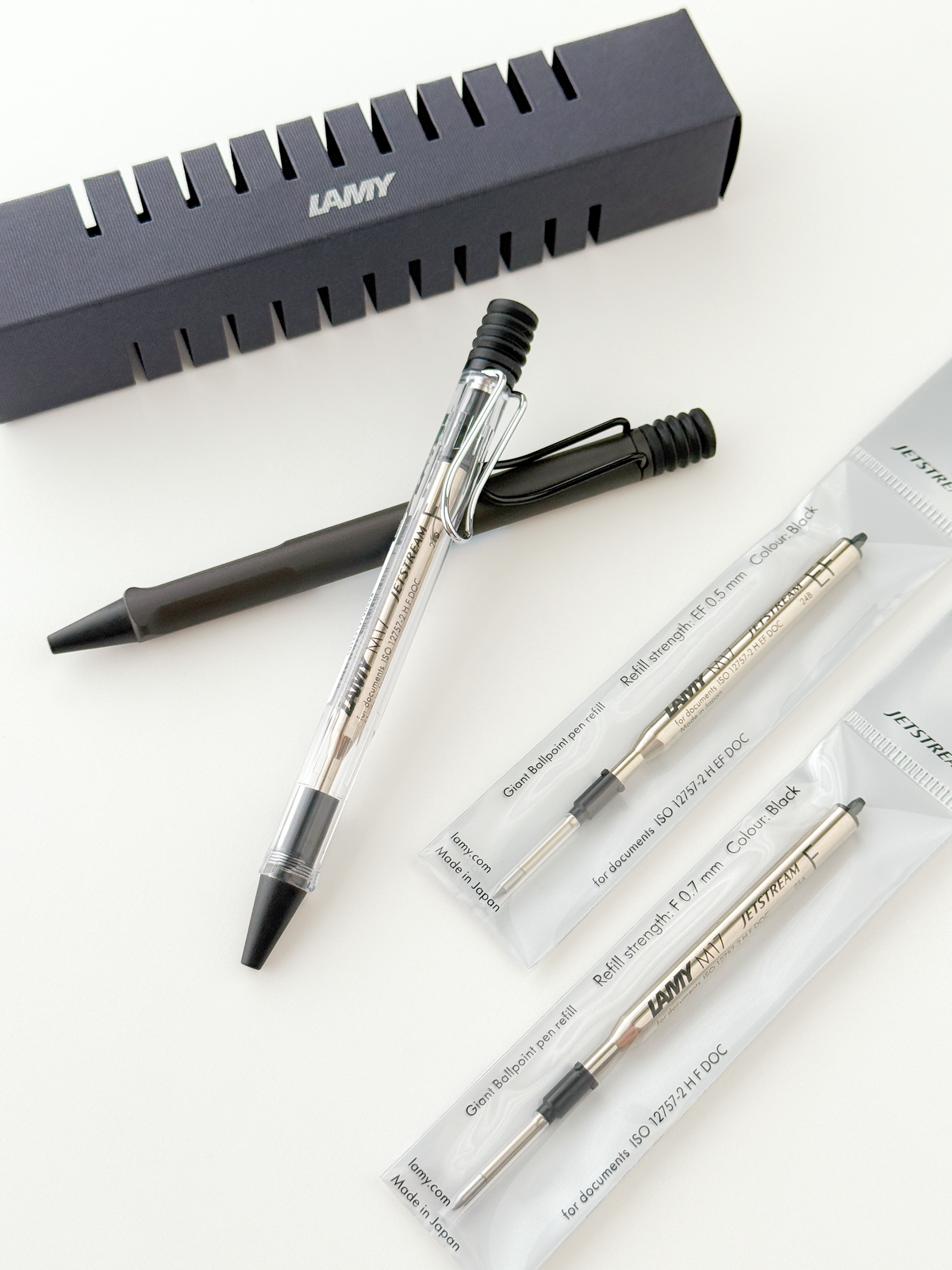 LAMY Safari JETSTREAM Inside Ballpoint Pen with clear barrel and black grip, shown with Jetstream refills and a branded LAMY box on a white background.